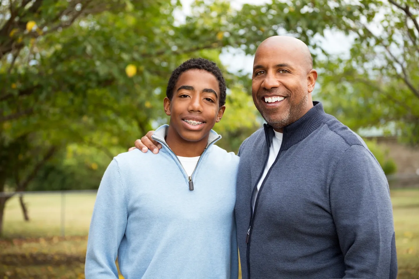 A man and boy standing next to each other.